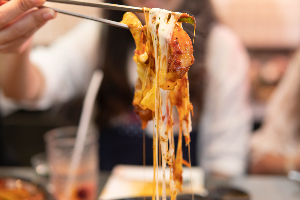 Korean street food: Cheesy tteokbokki (Korean spicy rice cake), South Korea.
